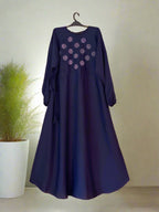 Navy blue dress with floral patterns on a hanger against a neutral background